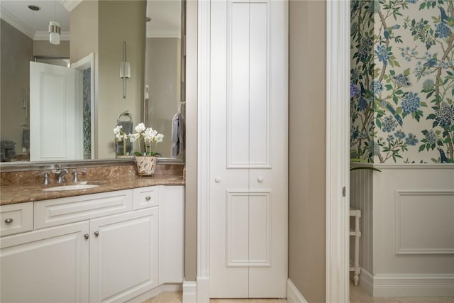 bathroom with vanity and ornamental molding