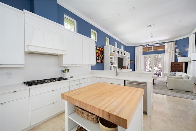 kitchen with sink, gas cooktop, white cabinets, and dishwasher