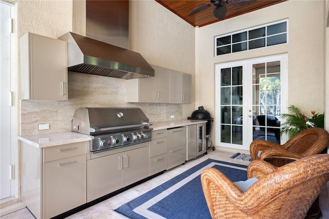 kitchen featuring wall chimney exhaust hood and gray cabinets