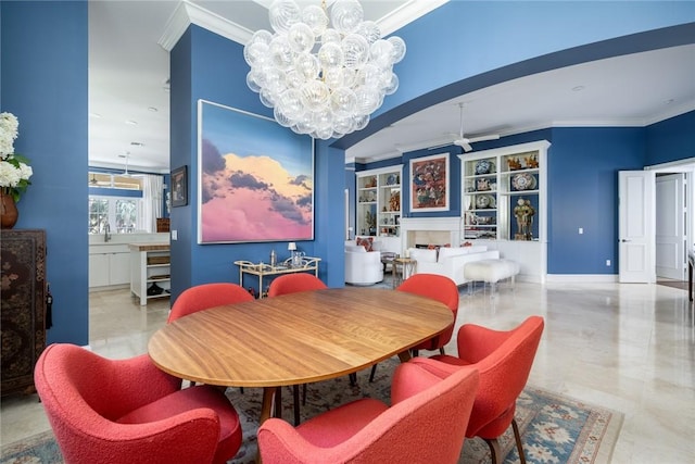 dining area with crown molding and ceiling fan with notable chandelier