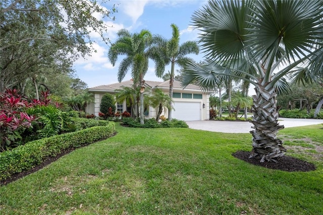 view of front of home with a garage and a front yard