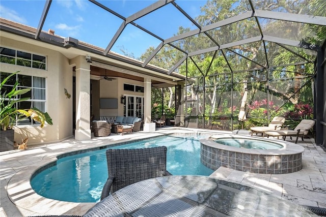 view of pool featuring ceiling fan, outdoor lounge area, a patio, glass enclosure, and an in ground hot tub