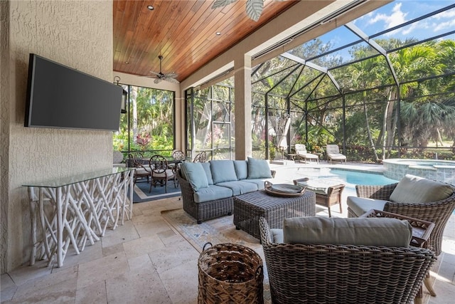 view of patio / terrace with a swimming pool with hot tub, outdoor lounge area, ceiling fan, and a lanai