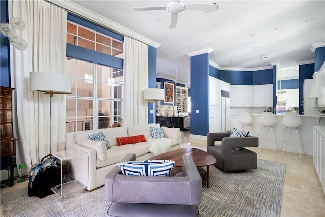 living room with crown molding and ceiling fan