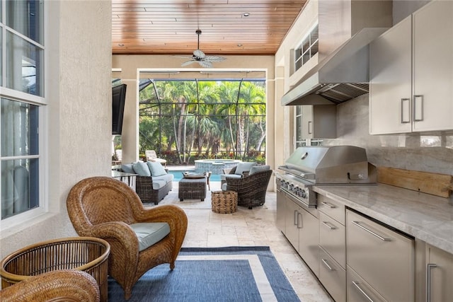 view of patio / terrace with a grill, outdoor lounge area, ceiling fan, and an outdoor kitchen