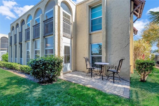 back of property with a patio and a yard