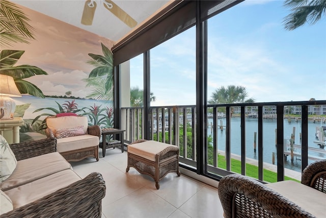 balcony with ceiling fan and a water view