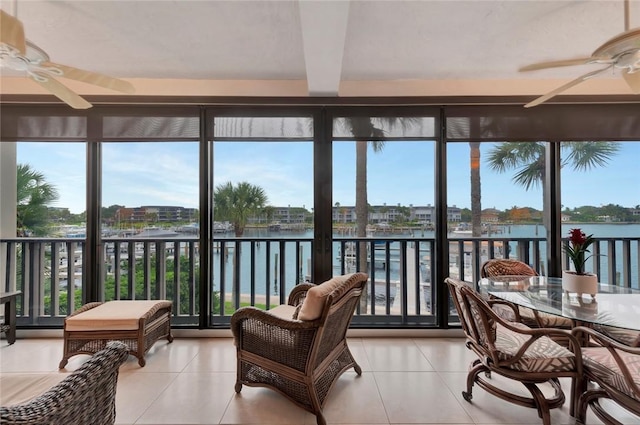 1875 Bay Rd Unit 215H, Vero Beach, FL 32963 - sunroom with a water view, tile patterned floors, healthy amount of natural light, and beamed ceiling
