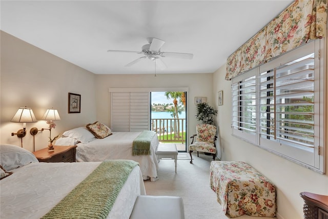 bedroom with access to exterior, ceiling fan, and light carpet