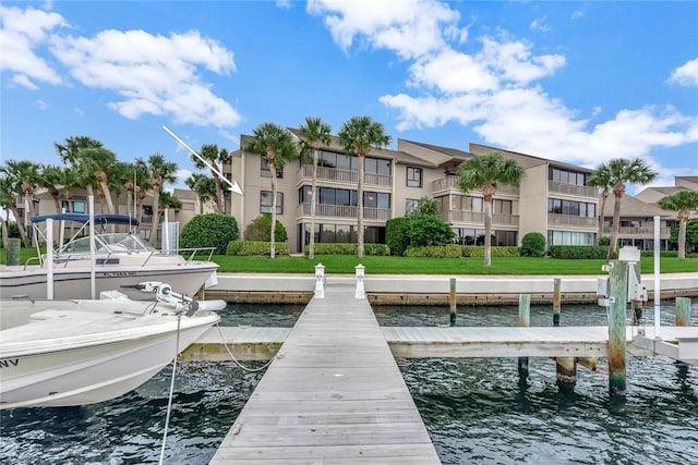 view of dock featuring a water view and a lawn