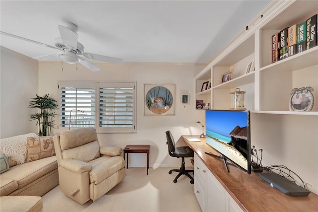 carpeted office space featuring ceiling fan