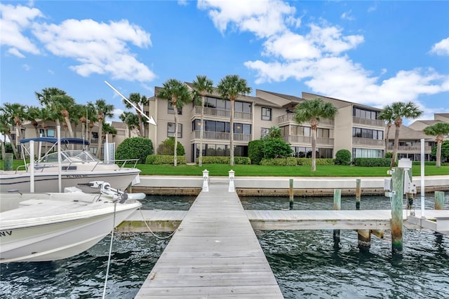 dock area featuring a water view and a yard