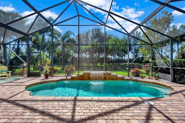 view of pool with pool water feature, a patio area, and a lanai