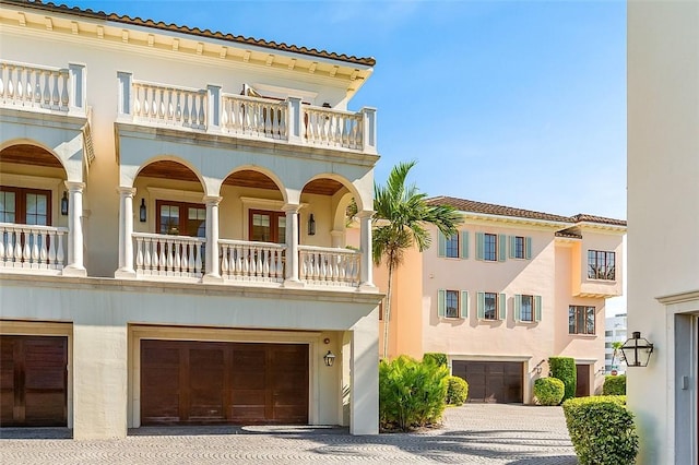 1507 Ocean Dr Unit 5, Vero Beach, FL 32963 - mediterranean / spanish-style home with a balcony, an attached garage, stucco siding, and driveway