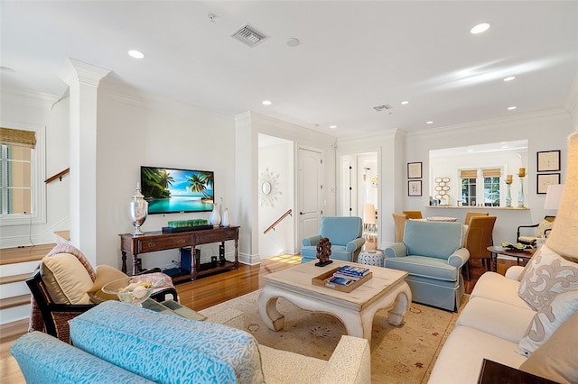 living room featuring light hardwood / wood-style flooring and ornamental molding