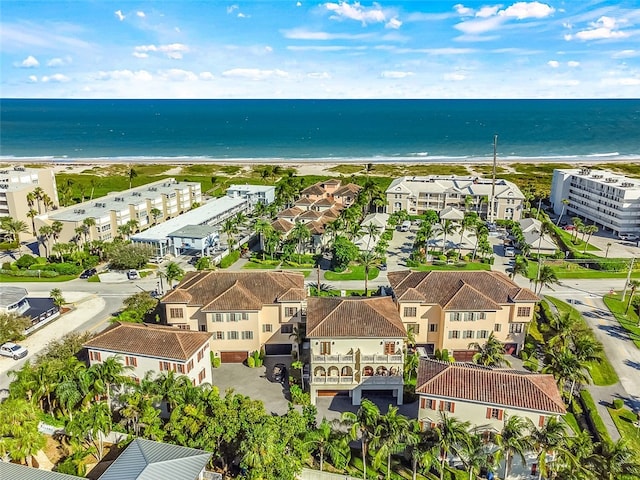 drone / aerial view with a water view and a beach view