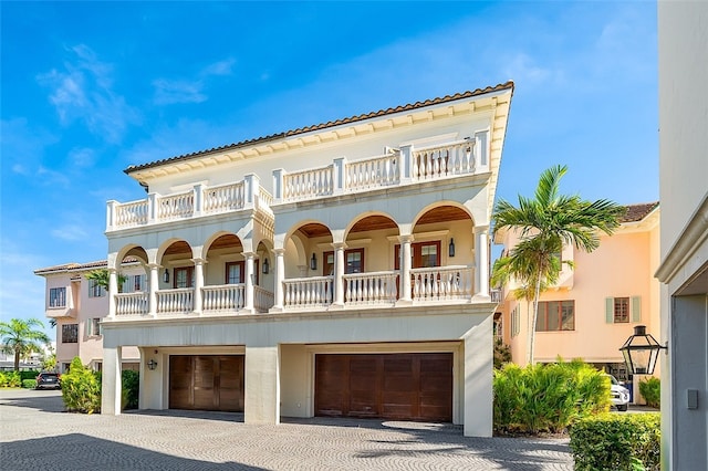 mediterranean / spanish home with a balcony and a garage