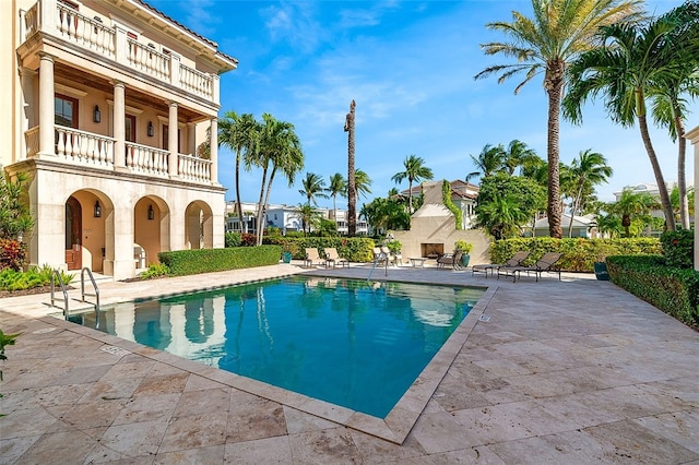 view of swimming pool with a patio