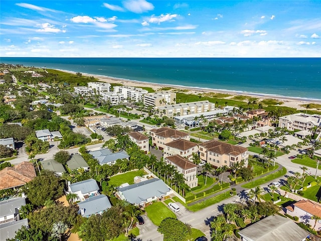 birds eye view of property featuring a water view and a beach view