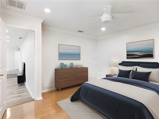 bedroom with ceiling fan, light wood-type flooring, and ornamental molding