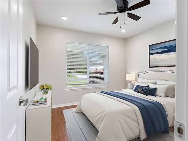 bedroom with ceiling fan and dark hardwood / wood-style floors