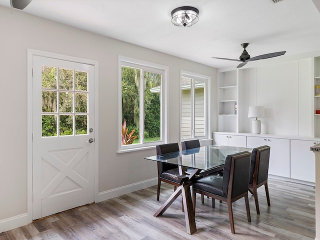 dining area featuring light wood-type flooring, ceiling fan, and a healthy amount of sunlight