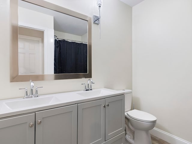 bathroom featuring hardwood / wood-style floors, vanity, and toilet