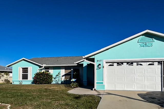 ranch-style home with a garage and a front yard