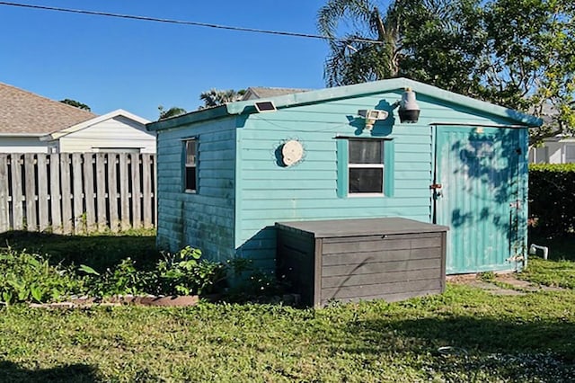 exterior space featuring a lawn and a storage unit