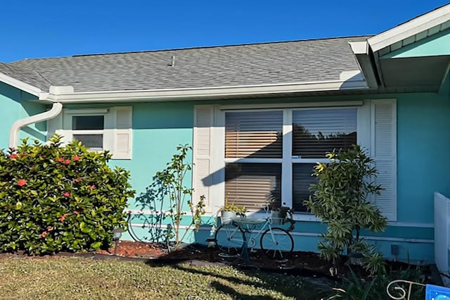 view of side of home with a yard