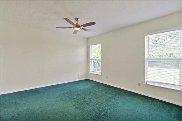 2225 86th Dr, Vero Beach, FL 32966 - empty room featuring dark carpet, ceiling fan, and baseboards