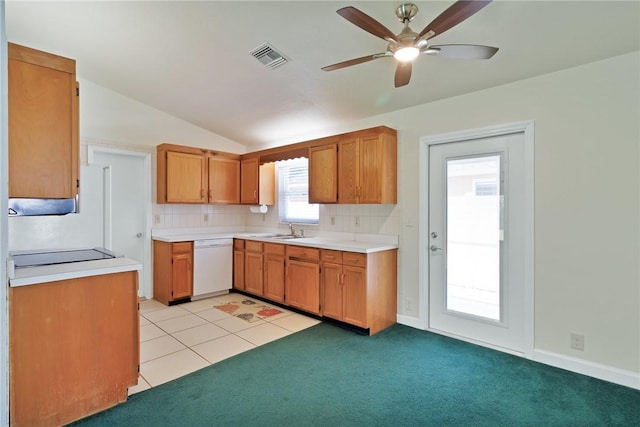 2225 86th Dr, Vero Beach, FL 32966 - kitchen with white dishwasher, a sink, a ceiling fan, decorative backsplash, and light countertops