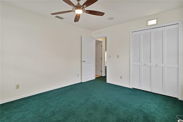 2225 86th Dr, Vero Beach, FL 32966 - unfurnished bedroom with dark colored carpet, baseboards, a closet, and ceiling fan