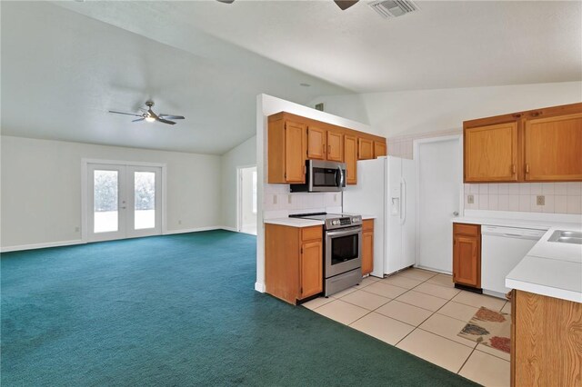 2225 86th Dr, Vero Beach, FL 32966 - kitchen featuring stainless steel appliances, ceiling fan, vaulted ceiling, backsplash, and light countertops