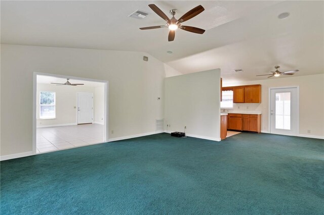 2225 86th Dr, Vero Beach, FL 32966 - unfurnished living room with a ceiling fan, lofted ceiling, baseboards, and carpet flooring