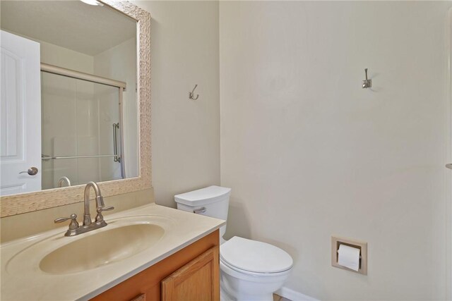 2225 86th Dr, Vero Beach, FL 32966 - bathroom with toilet, vanity, and a shower with shower door