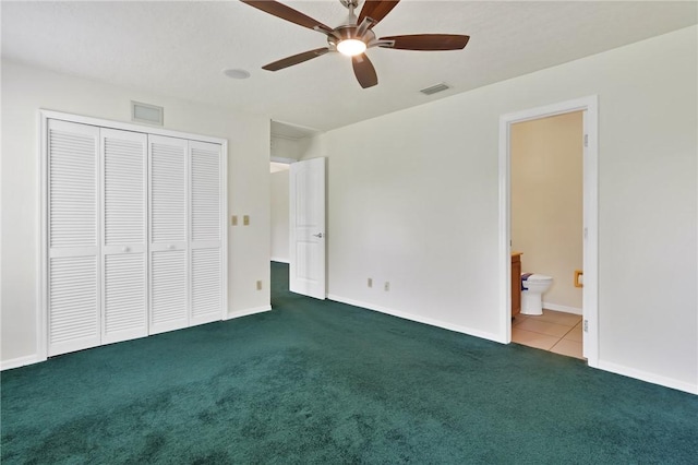 2225 86th Dr, Vero Beach, FL 32966 - unfurnished bedroom with carpet, a closet, connected bathroom, baseboards, and a ceiling fan