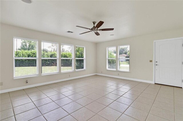 2225 86th Dr, Vero Beach, FL 32966 - empty room with light tile patterned floors, a ceiling fan, and baseboards