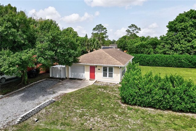 2225 86th Dr, Vero Beach, FL 32966 - ranch-style house featuring driveway, an attached garage, and a front lawn