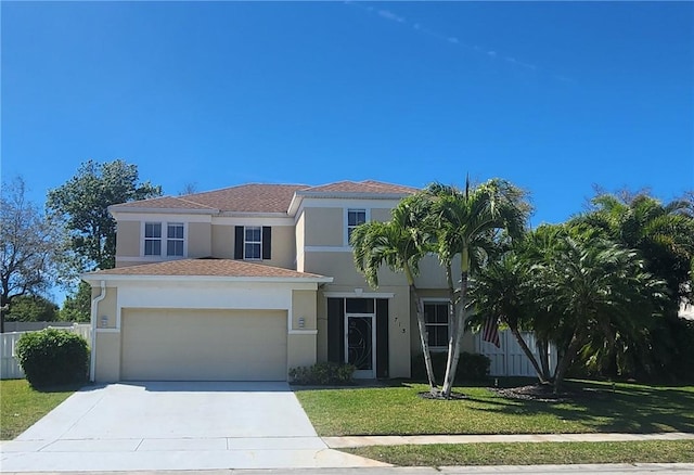 view of front of house with concrete driveway, a front lawn, fence, and stucco siding