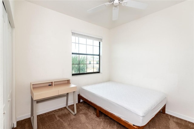 carpeted bedroom featuring ceiling fan and a closet