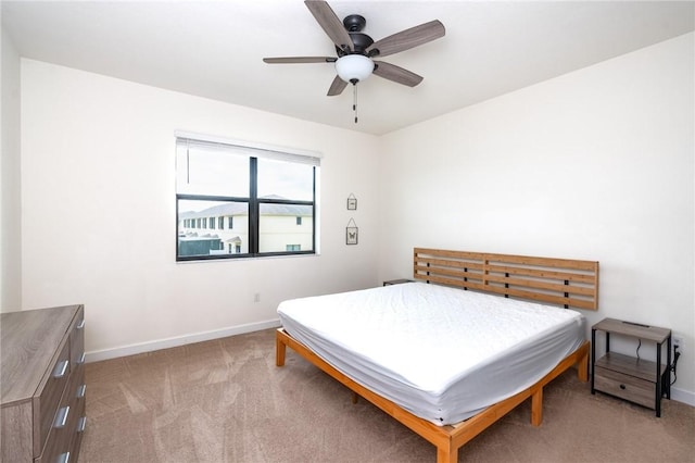 bedroom featuring light colored carpet and ceiling fan