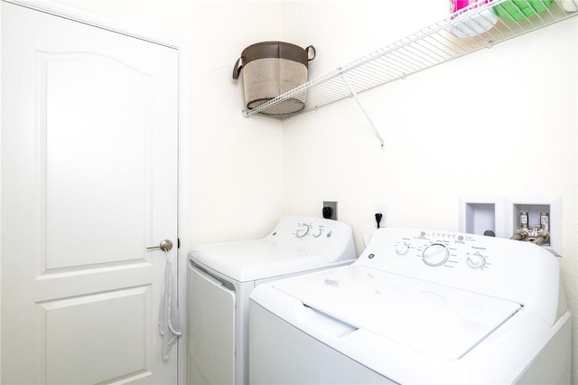 washroom featuring washer and clothes dryer