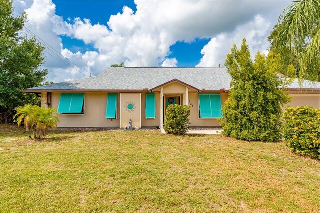 125 Capri Ave, Sebastian, FL 32958 - ranch-style home with a shingled roof and a front yard