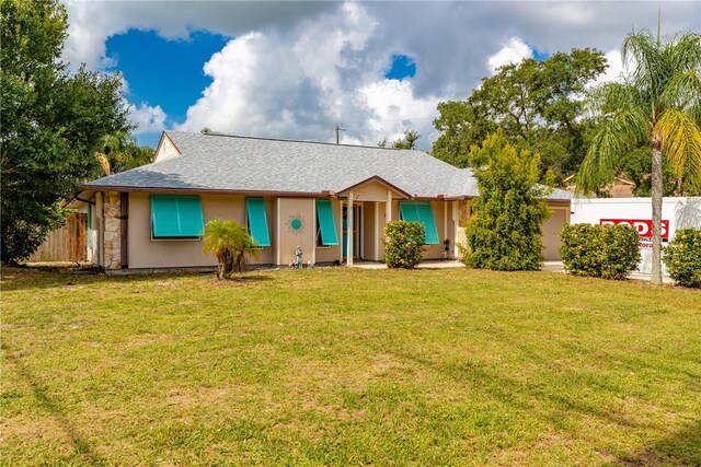 125 Capri Ave, Sebastian, FL 32958 - kitchen featuring stainless steel appliances, a sink, a peninsula, a breakfast bar area, and light tile patterned flooring