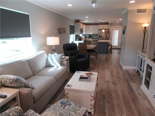 living room with crown molding and dark wood-type flooring