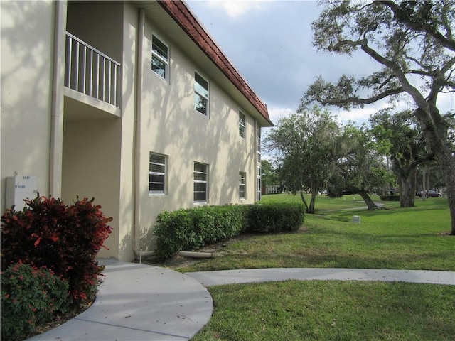 view of side of property with a yard