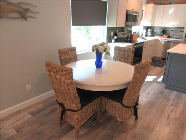 dining room with light wood-type flooring