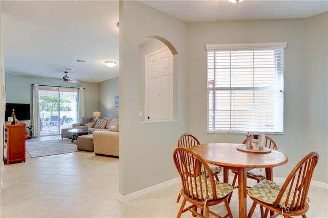 6375 Oxford Cir Unit 104D, Vero Beach, FL 32966 - dining space featuring light tile patterned floors, ceiling fan, visible vents, baseboards, and arched walkways