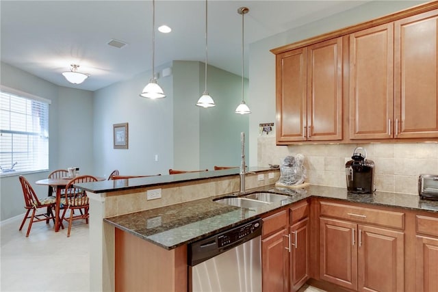 6375 Oxford Cir Unit 104D, Vero Beach, FL 32966 - kitchen with dark stone countertops, tasteful backsplash, a peninsula, and dishwasher